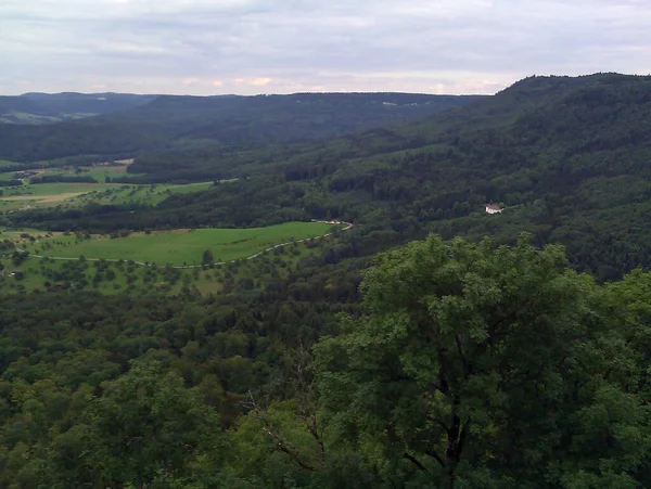 Widok Dolinę Pomiędzy Wzgórzami Pokrytymi Zielonymi Drzewami Daleka Widać Dom — Zdjęcie stockowe