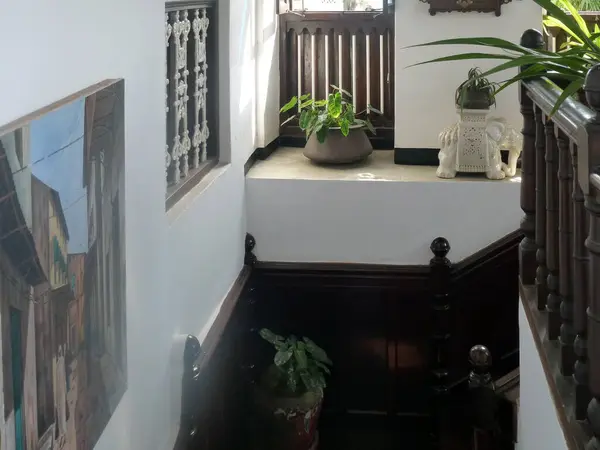 Apartment interior design with stairs, wooden railings and flower pots. An example of apartment decorations