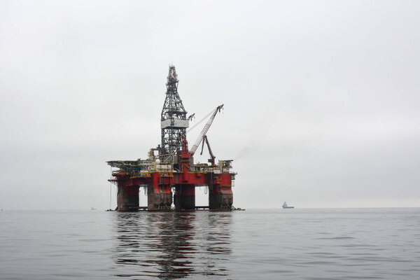 Oil drilling platform in a calm sea. Pollution of the marine environment and industry