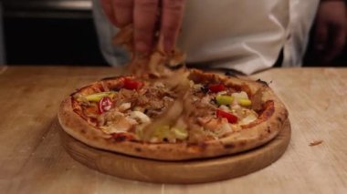 Şef restoranda pizza hazırlıyor.