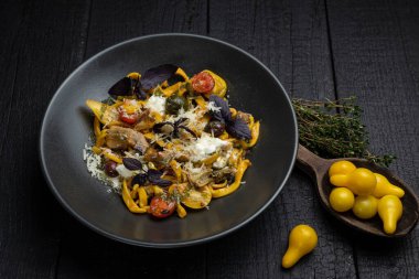 Lokantadaki karanlık bir masada lezzetli bir makarna.