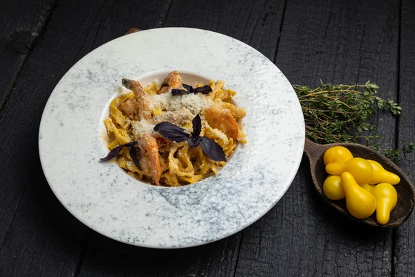 stock image delicious pasta on a dark table in a restaurant