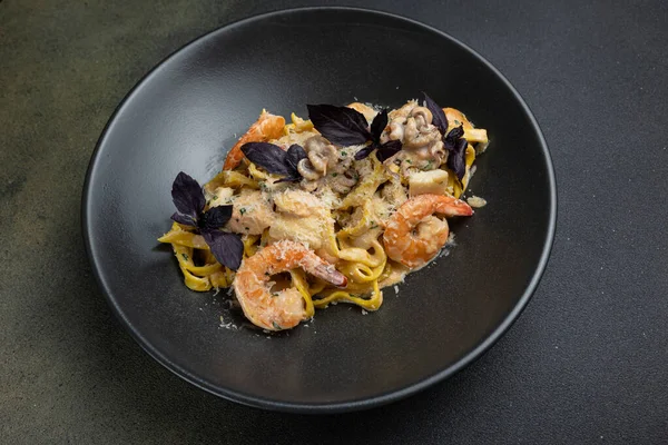 stock image delicious pasta on a dark table in a restaurant