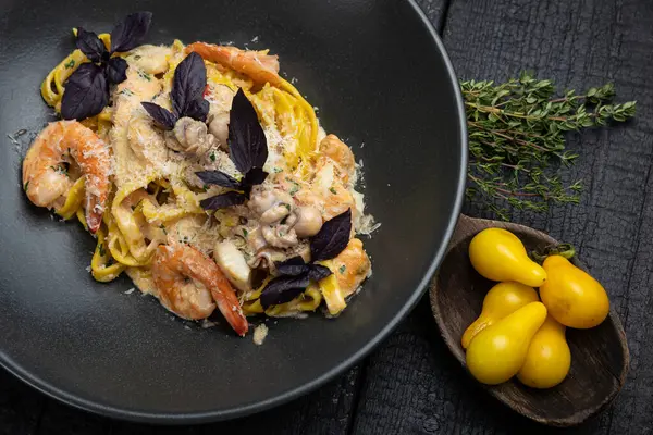 stock image delicious pasta on a dark table in a restaurant