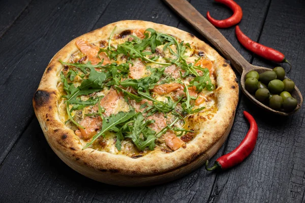 stock image tasty pizza with cheese and vegetables on a wooden dark table