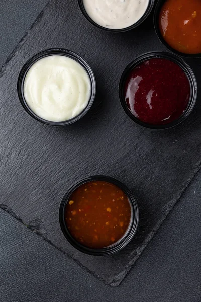 sauces of Asian cuisine on a black background