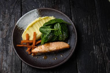 delicious salmon dish on a plate prepared in a restaurant.