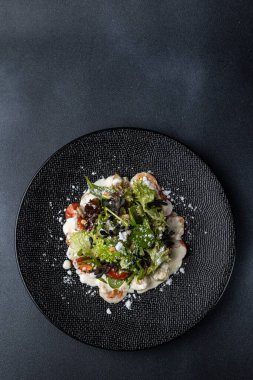a delicious salad on a plate prepared in a restaurant.