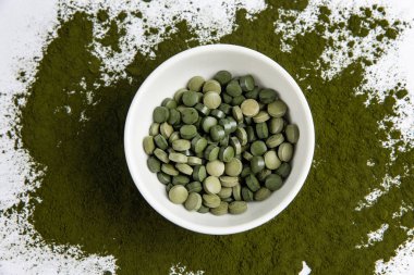 Spirulina is a useful supplement. on a white background