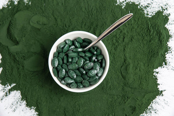 Spirulina is a useful supplement. on a white background