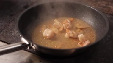 the chef prepares seafood pasta