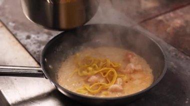the chef prepares seafood pasta