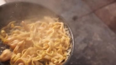 the chef prepares seafood pasta