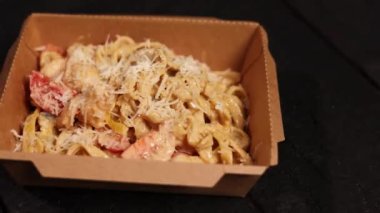 the chef prepares seafood pasta