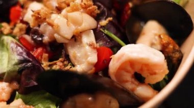 the chef prepares a delicious seafood salad