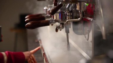 a bartender brews coffee in a cafe