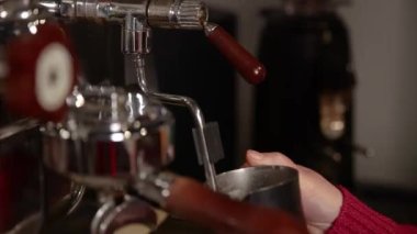 a bartender brews coffee in a cafe