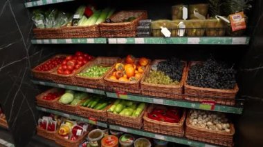 shelves with fruits and vegetables in a supermarket