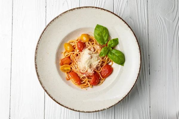 Stock image delicious pasta in a plate on a white wooden table. close-up