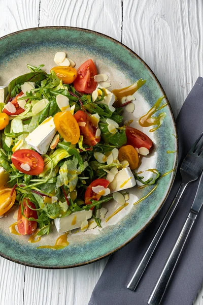 stock image delicious salad on a white wooden table. close-up