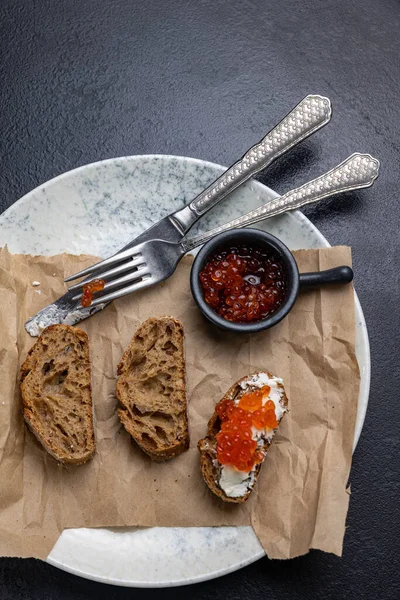 stock image A plate of toasts with red caviar