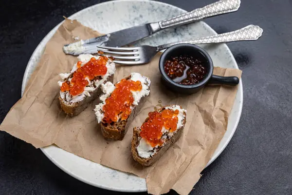 stock image A plate of toasts with red caviar