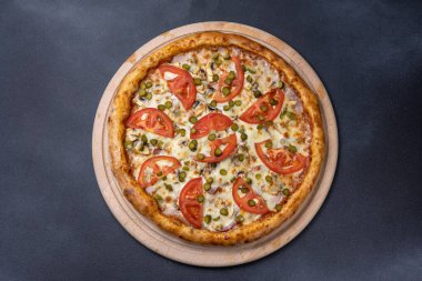 İtalyan mutfağı. Koyu arkaplanda lezzetli bir pizza.