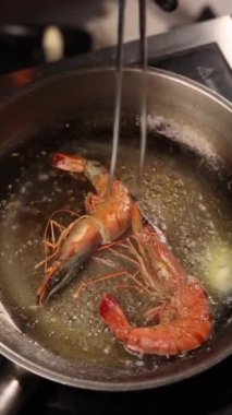 Kızartma tavasında baharatla tereyağında kızartılmış kaplan karidesi.