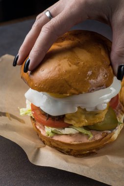 Peynirli, sebzeli ve pirzolalı lezzetli hamburger.