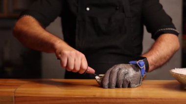 Restoranda istiridye hazırlayan bir aşçı.