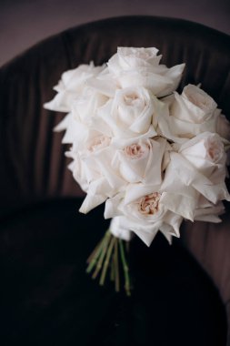 beautiful bouquet flowers and accessories for the wedding ceremony on chair, the concept of beauty