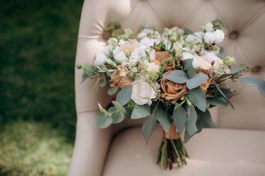 beautiful bouquet flowers and accessories for the wedding ceremony on chair, the concept of beauty