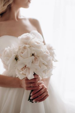 beautiful young bride with bouquet of flowers in brides hands