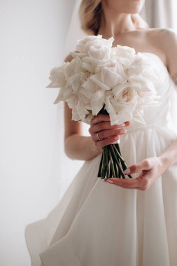beautiful young bride with bouquet of flowers in brides hands