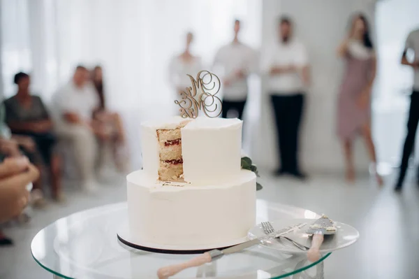 cut wedding cake with knife and cutlery