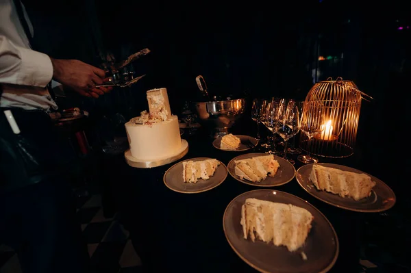 cut wedding cake with knife and cutlery