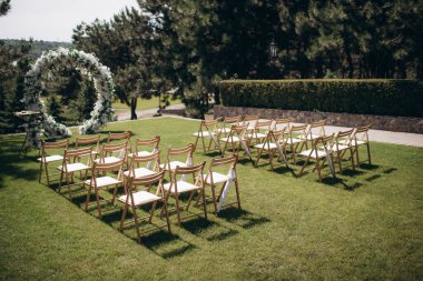 wedding ceremony arch with empty chairs and flowers. beautiful romantic decoration