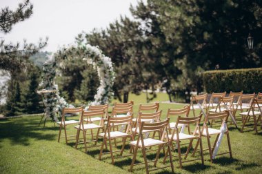 wedding ceremony arch with empty chairs and flowers. beautiful romantic decoration