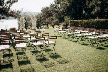 wedding ceremony arch with empty chairs and flowers. beautiful romantic decoration