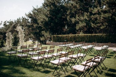 wedding ceremony arch with empty chairs and flowers. beautiful romantic decoration