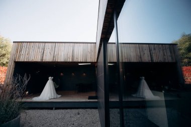 chic elegant wedding dress on a mannequin on the terrace of the house