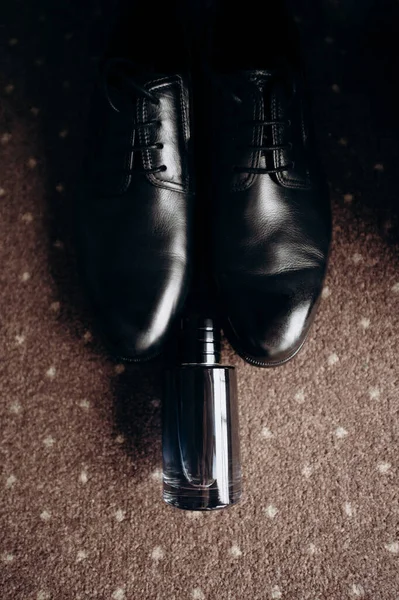 Bir çift ayakkabı ve bir şişe parfüm.