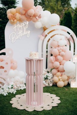 Çiçekli ve balonlu küçük doğum günü pastası.