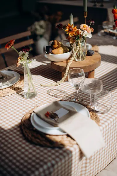 Çiçek aranjmanları ve mumlarla şenlik masası. Sıcak, zarif bir atmosfer.
