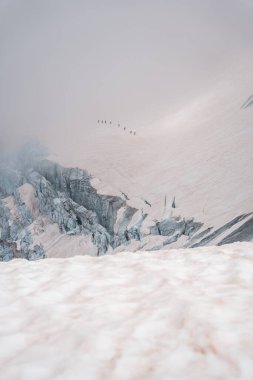 A group of climbers crossing a glacier in Switzerland clipart