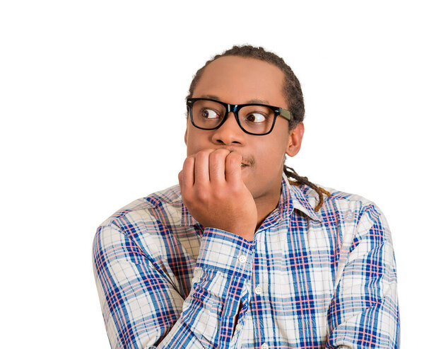 Portrait of an anxious young man biting his nails fingers freaking out