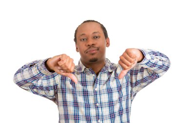 Closeup portrait, unhappy, angry, mad, pissed off man, annoyed, giving thumbs down gesture, looking with negative facial expression, disapproval, isolated on white 