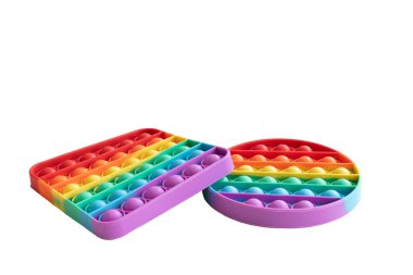 Pair of differently shaped rainbow colored popits. A bubble fidget sensory toy isolated on a white background.