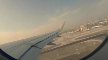 Dubai, United Arab Emirates - 11th October, 2019: Passenger POV of a flight taking off from Dubai International Airport in the morning with beautiful views of the cityscape below.