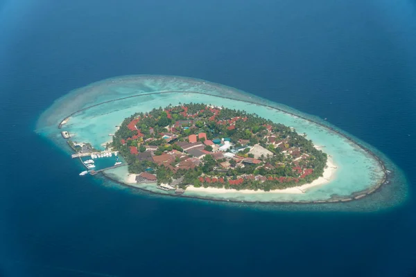 Beautiful aerial view of a remote island in one of the many atolls in the Maldives. Remote tropical island holiday destination concept.